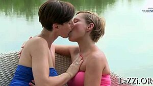 Two short-haired beauties indulge in some steamy pussy play by a lake